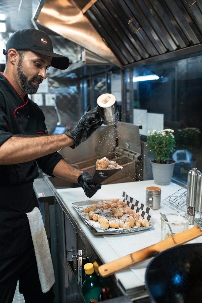 Sprinkling of Powdered Sugar on Beignet Fritters 